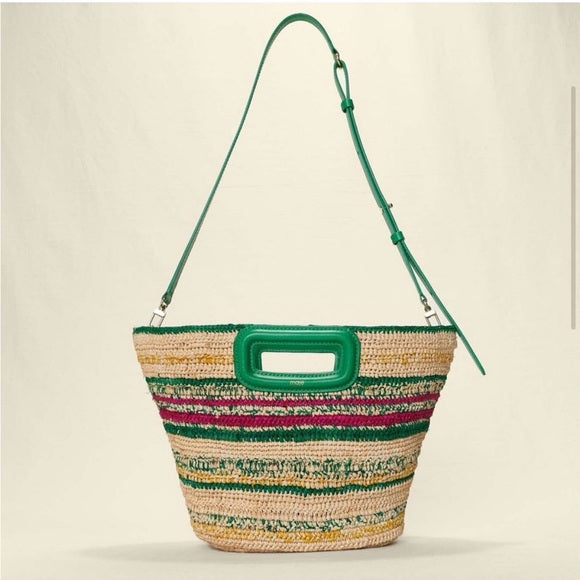 Woven bag with green handle and trim on a beige background. Summer Bag discounted