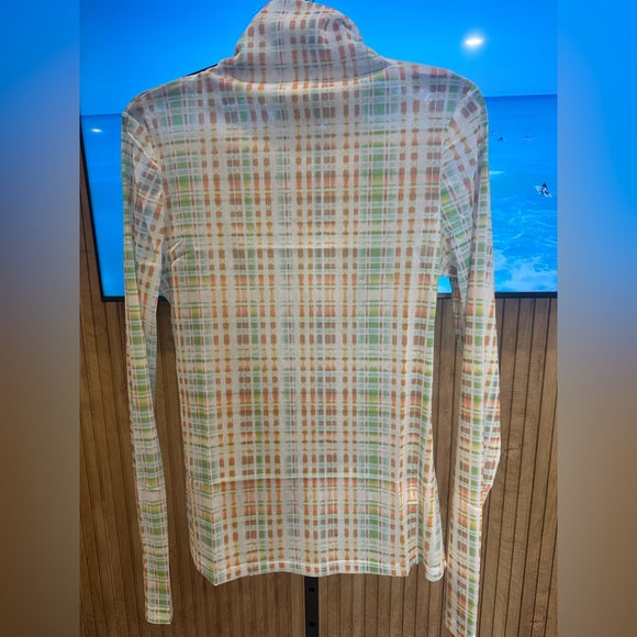 Plaid shirt on a mannequin against a blue wall