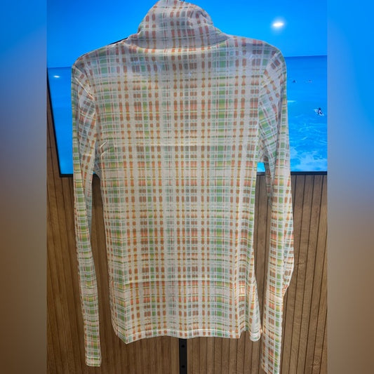 Plaid shirt on a mannequin against a blue wall