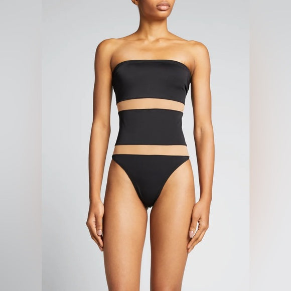 Black bikini set worn by a model on a plain background